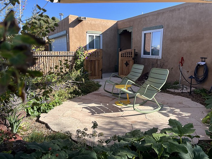 Santa Fe/ small patio/fence/gate/landscape/tree planting.